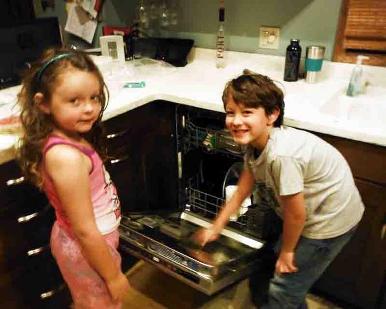 Children taking bacterial samples from dirty dishes in dishwasher